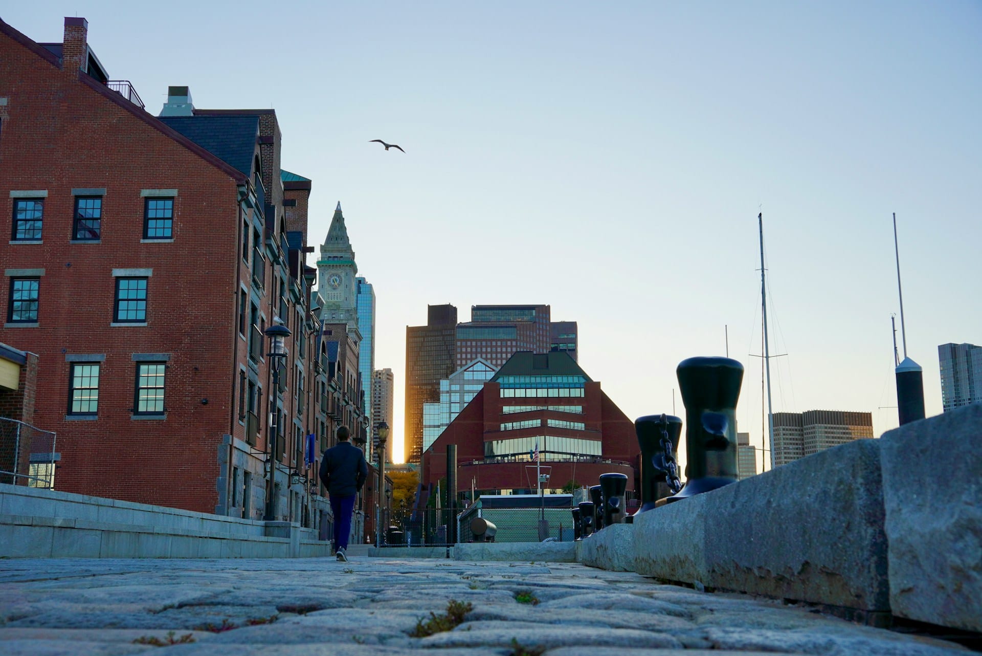 A city street of brick buildings at sunset